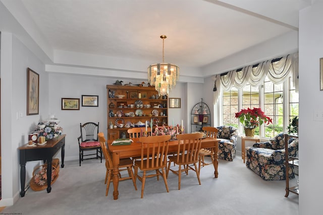 carpeted dining room featuring an inviting chandelier