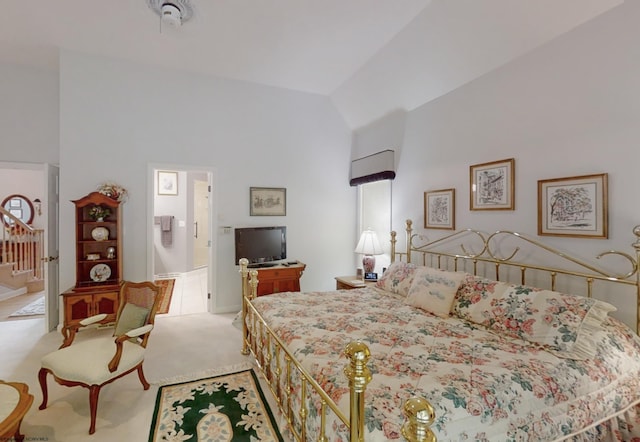 carpeted bedroom with high vaulted ceiling