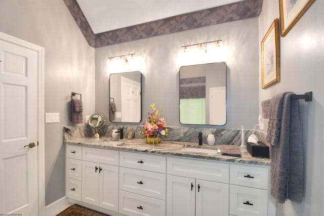 bathroom with double vanity and backsplash