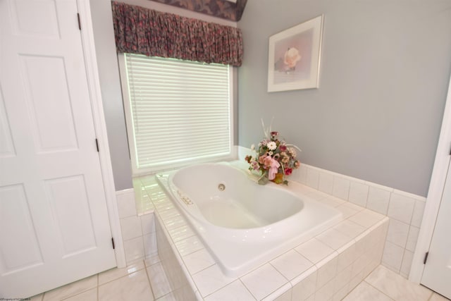 bathroom with tile flooring and a relaxing tiled bath