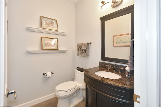 bathroom featuring vanity, toilet, and tile floors