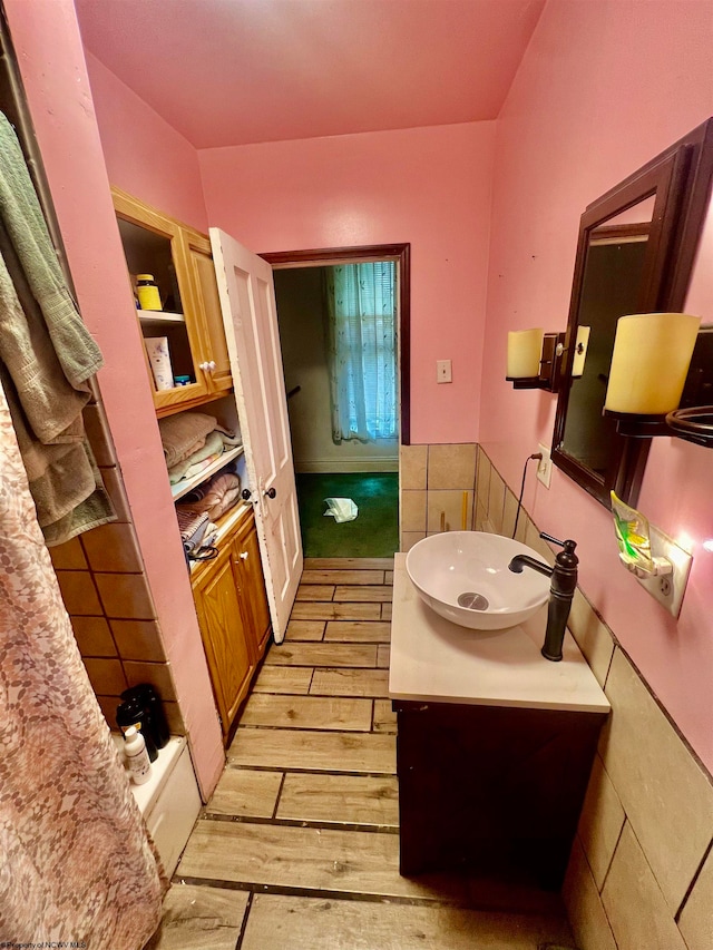 bathroom with hardwood / wood-style flooring and vanity