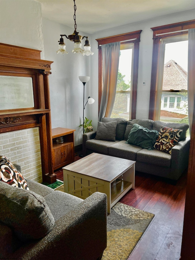 living room featuring a chandelier and dark hardwood / wood-style floors