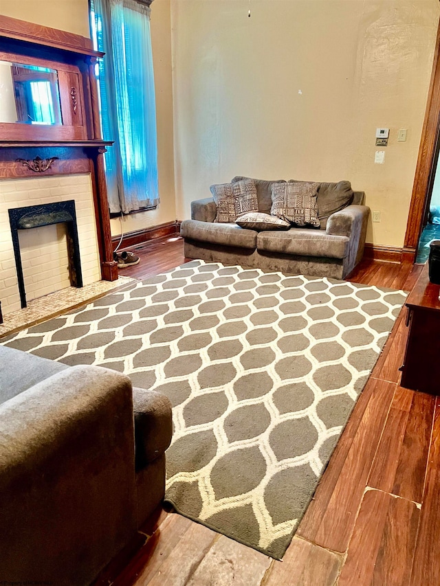 living room with a fireplace and hardwood / wood-style flooring