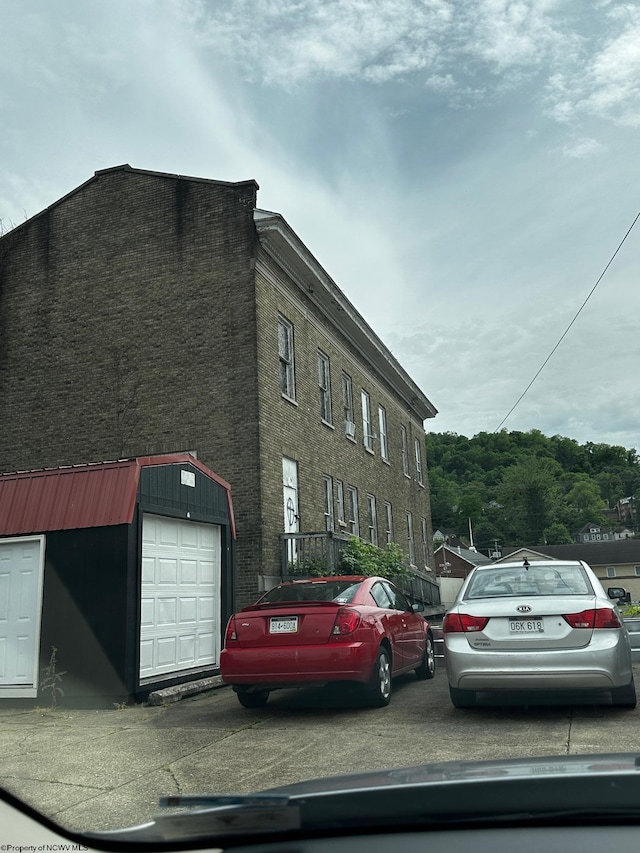 exterior space featuring a garage and an outdoor structure