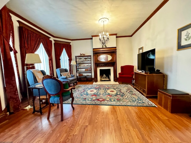 living room with an inviting chandelier, crown molding, and wood-type flooring