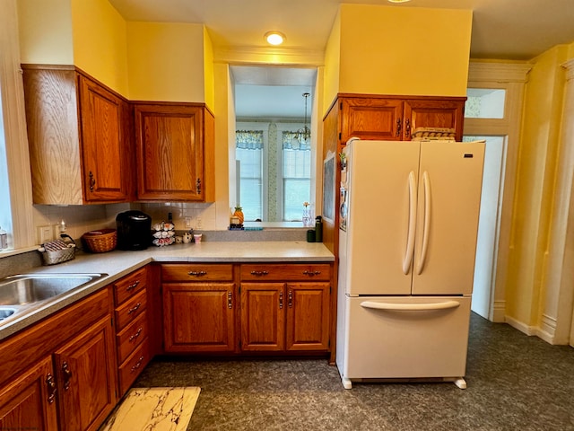 kitchen with a wealth of natural light, white fridge, and backsplash