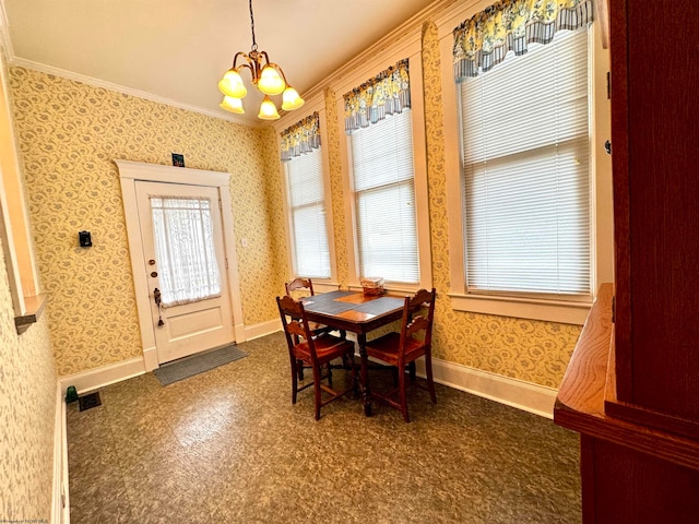 dining room with a chandelier and crown molding