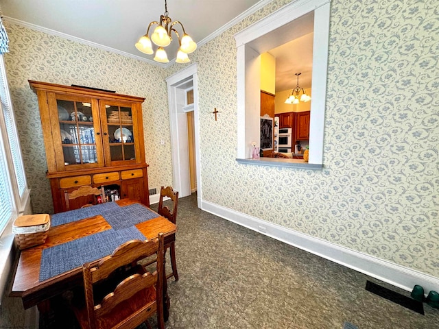 dining area featuring ornamental molding and an inviting chandelier