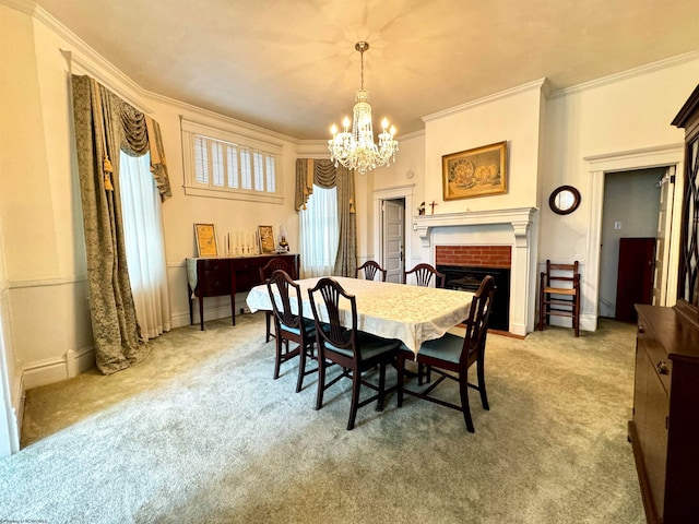 carpeted dining room featuring crown molding, a fireplace, and a notable chandelier