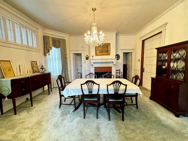 carpeted dining space featuring crown molding, a fireplace, and an inviting chandelier