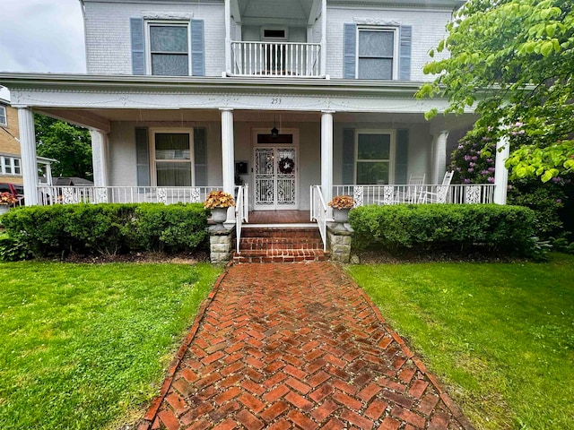 exterior space featuring covered porch and a yard