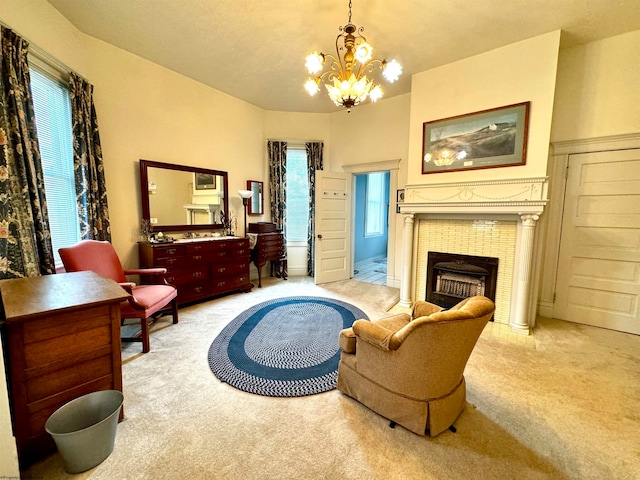 living room featuring carpet floors, a tile fireplace, and a chandelier