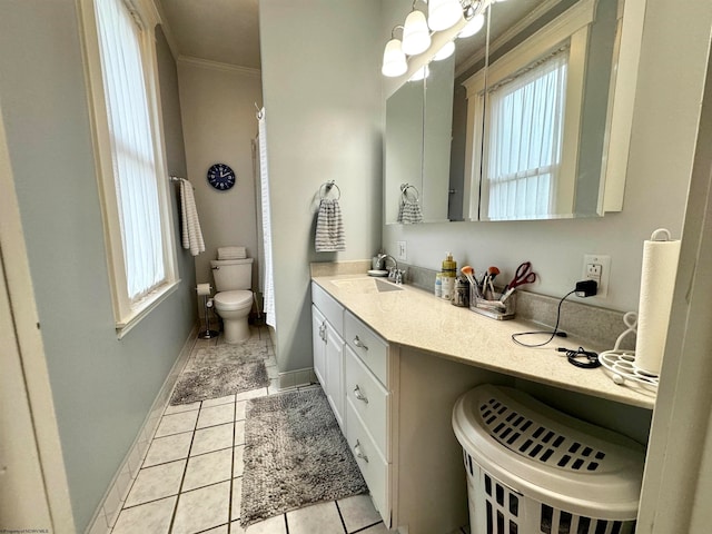 bathroom with tile floors, ornamental molding, vanity, and toilet