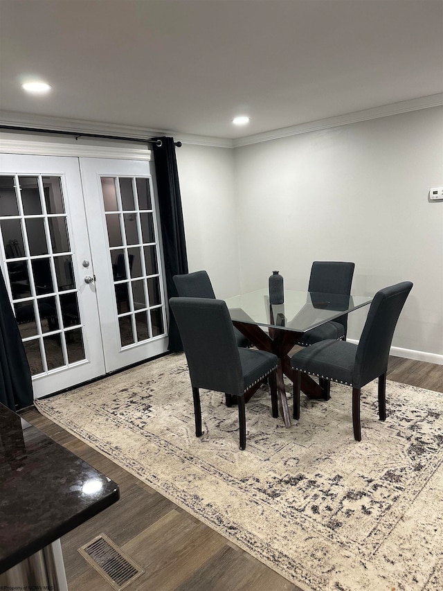 dining room featuring dark hardwood / wood-style floors, french doors, and crown molding