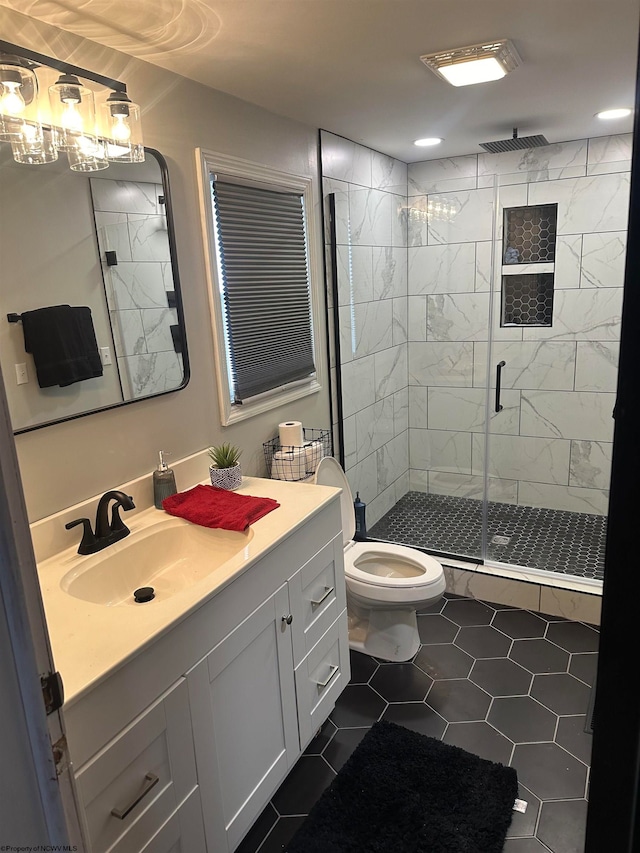 bathroom featuring an enclosed shower, vanity, toilet, and tile floors