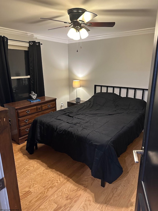 bedroom with ornamental molding, ceiling fan, and light hardwood / wood-style flooring