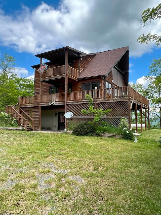 back of property with a lawn and a balcony