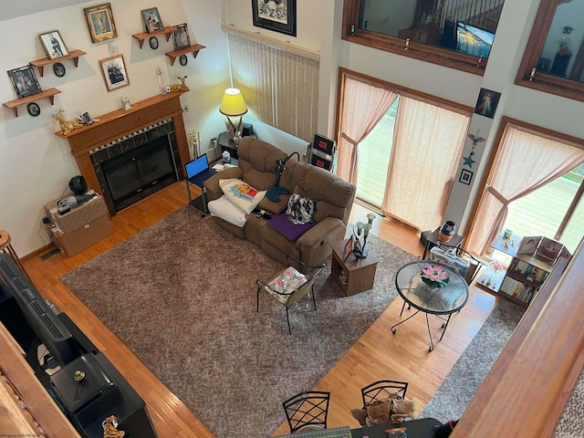 living room featuring hardwood / wood-style floors and a towering ceiling