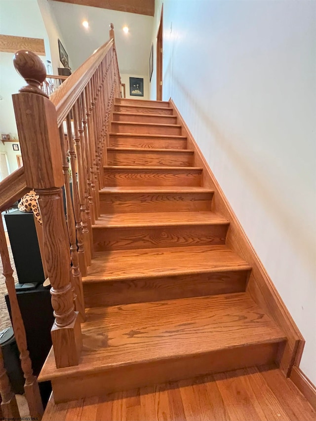 staircase featuring wood-type flooring