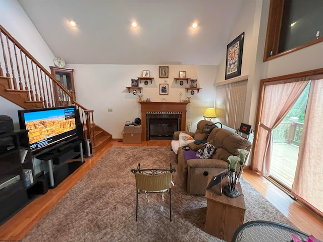 living room with hardwood / wood-style floors and lofted ceiling