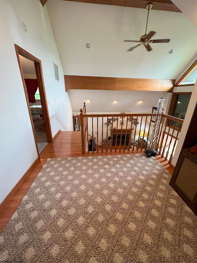 interior space featuring hardwood / wood-style floors, ceiling fan, and high vaulted ceiling