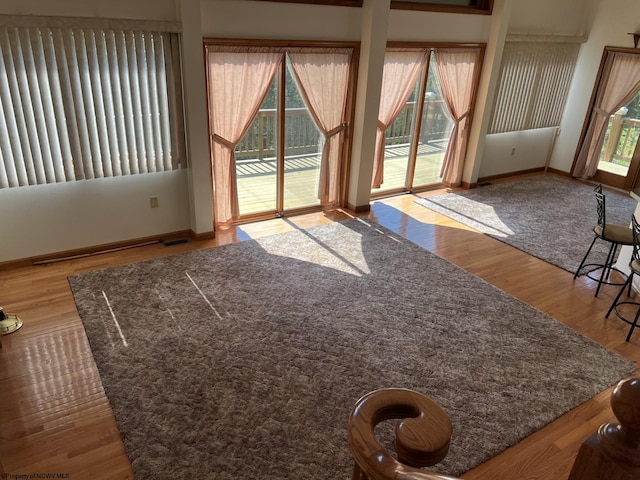 unfurnished living room featuring hardwood / wood-style floors and a wealth of natural light