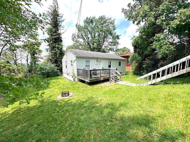 view of yard featuring a wooden deck and a fire pit