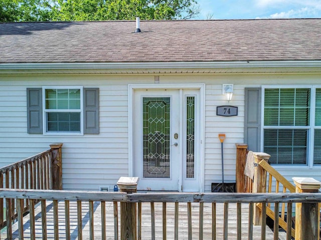 property entrance featuring a deck and french doors