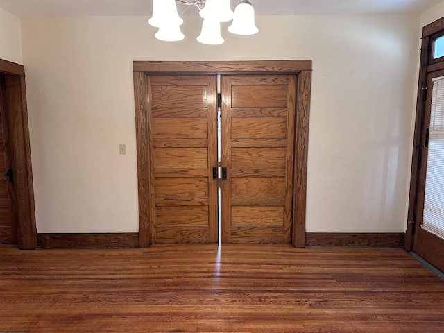 foyer featuring a chandelier and dark hardwood / wood-style floors