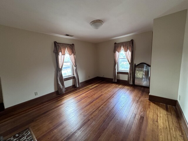 empty room with dark wood-type flooring