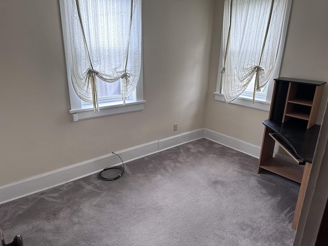 unfurnished bedroom with dark colored carpet