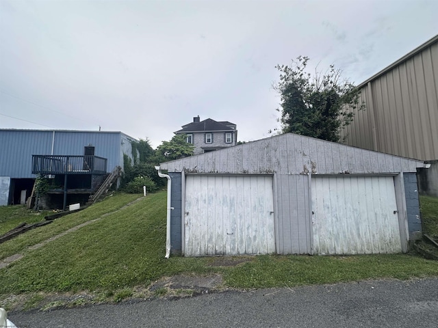 view of outbuilding with a lawn and a garage