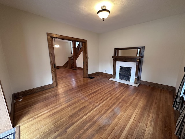 unfurnished living room featuring hardwood / wood-style floors and a fireplace