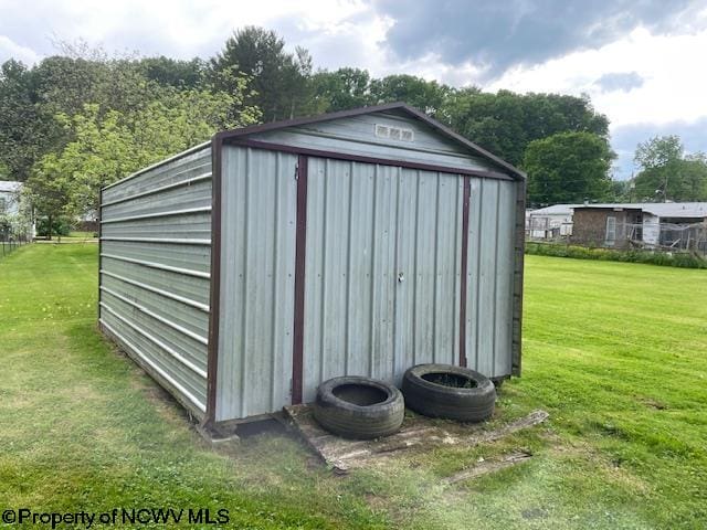 view of outbuilding featuring a yard