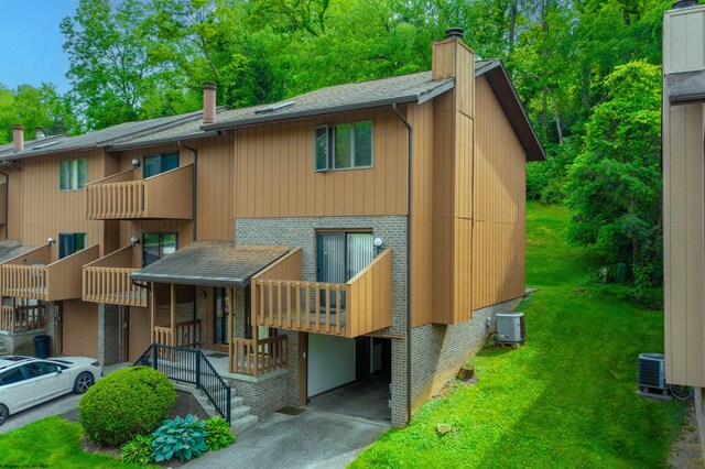 exterior space featuring a carport, central AC unit, and a front lawn