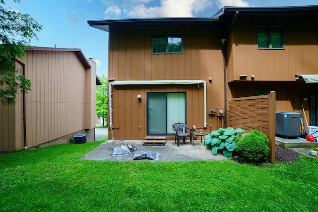 back of house with a yard, a patio area, and central air condition unit