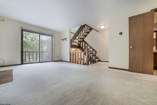 unfurnished living room featuring carpet flooring