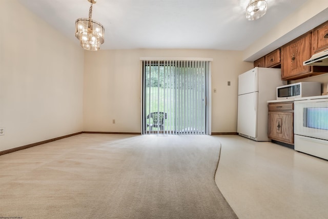 kitchen featuring hanging light fixtures, an inviting chandelier, light colored carpet, and white appliances