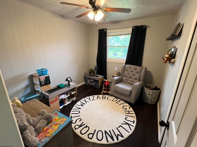 sitting room with ceiling fan and wood-type flooring