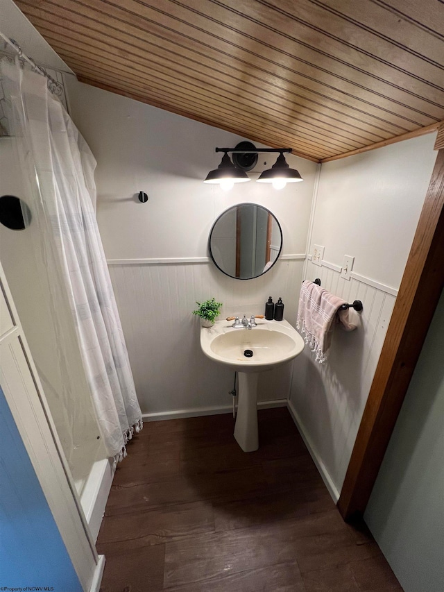 bathroom with hardwood / wood-style flooring and wood ceiling