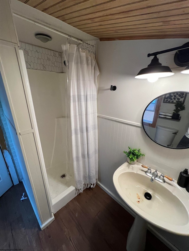 bathroom with wood-type flooring, a shower with shower curtain, sink, and wood ceiling