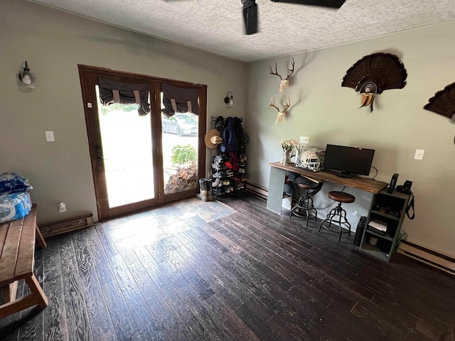 office area featuring a textured ceiling, hardwood / wood-style flooring, and baseboard heating