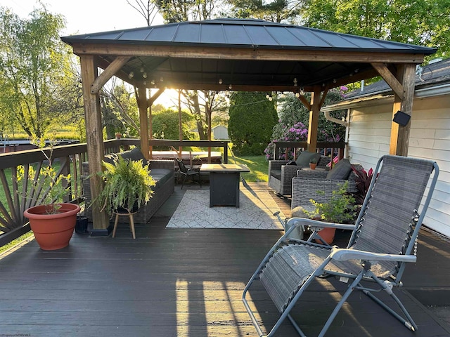 wooden terrace with an outdoor hangout area and a gazebo