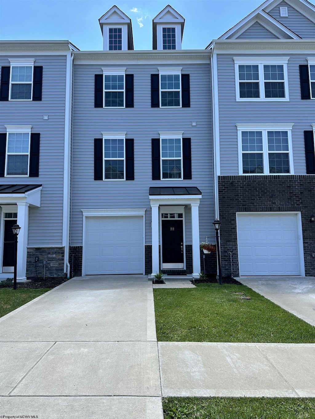 multi unit property featuring a garage