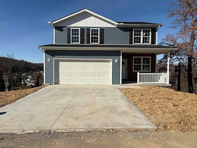 front of property with covered porch and a garage