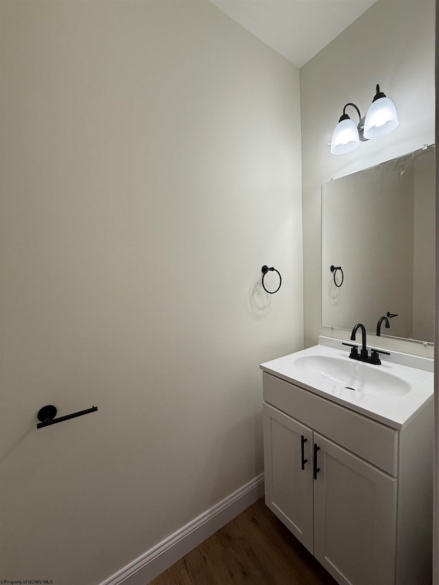 bathroom with vanity and wood-type flooring