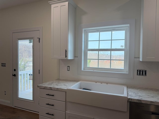 kitchen with white cabinetry and plenty of natural light