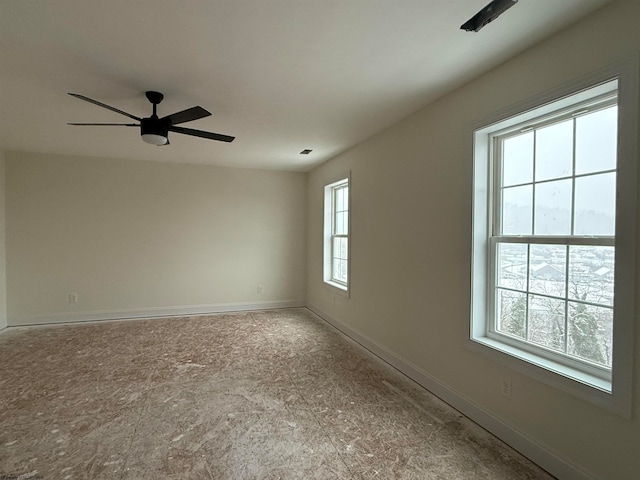 unfurnished room featuring a wealth of natural light and ceiling fan