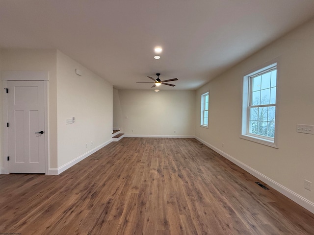 empty room with ceiling fan and hardwood / wood-style flooring